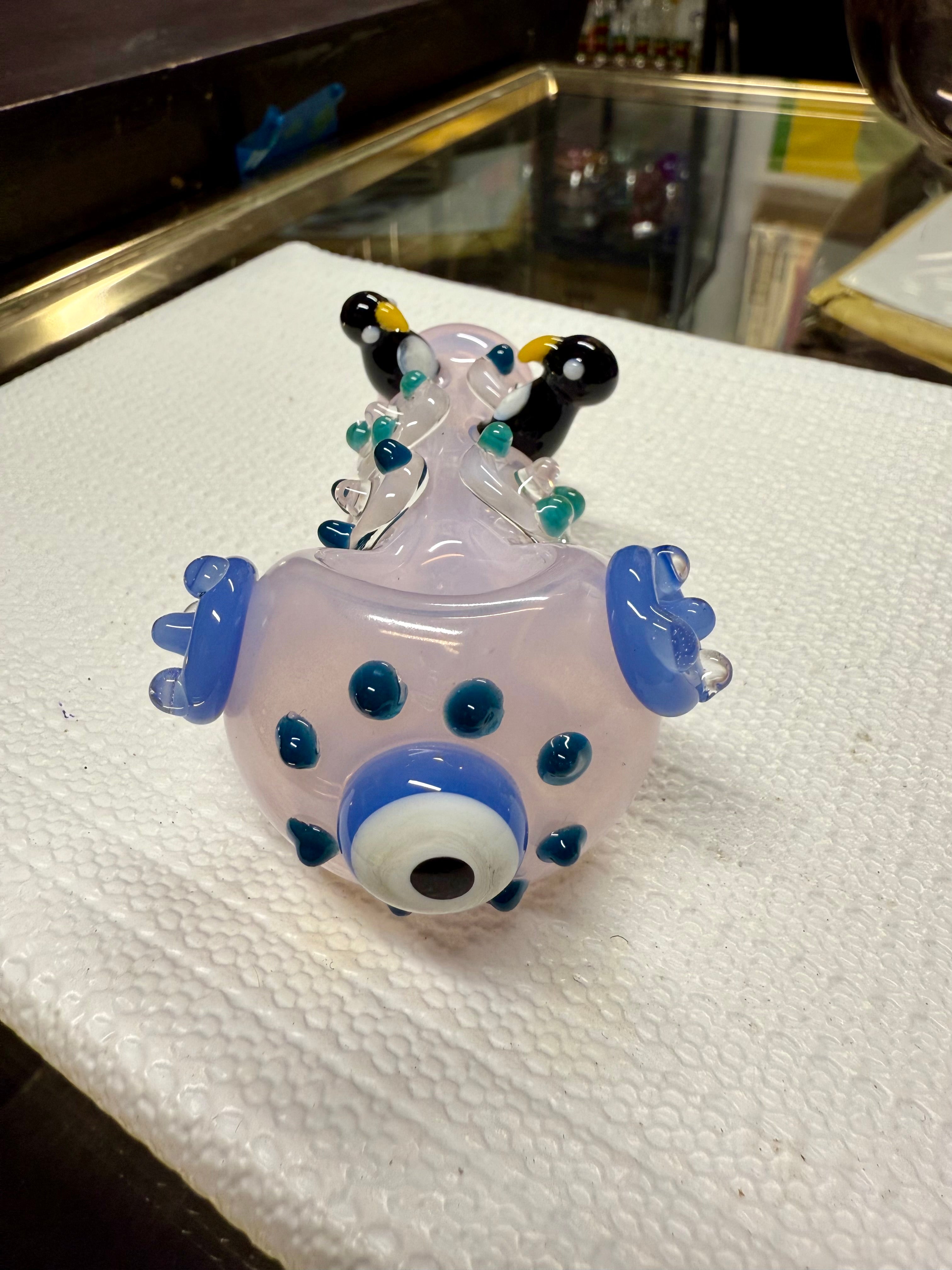 Ripkitty penguin art pipe — pink colorway, three-quarter angle showing penguin sculpts, dot pattern