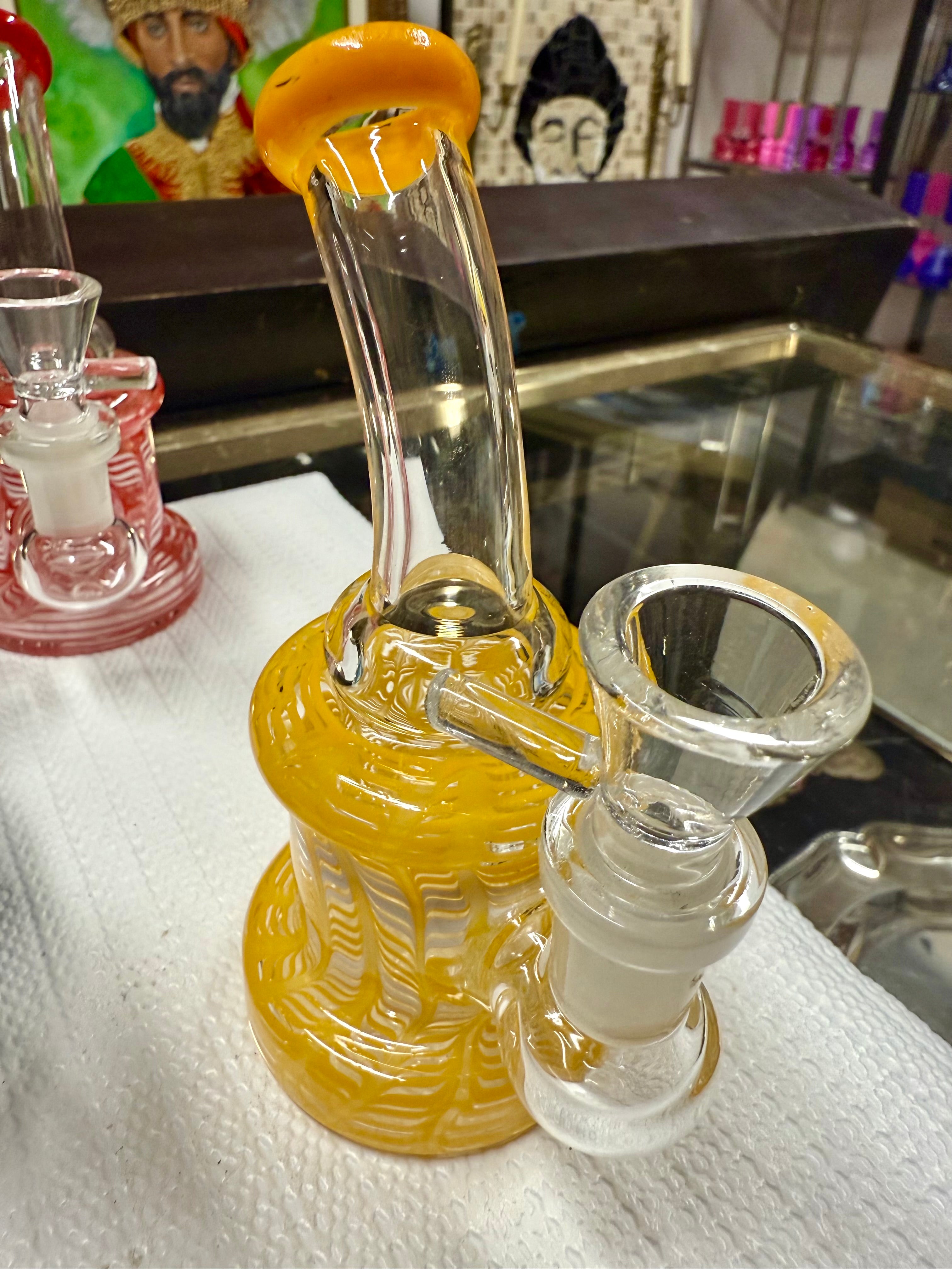 Close-up of Ripkitty 5" fancy mini bong base and bowl joint — rod yellow color glass detailing visible