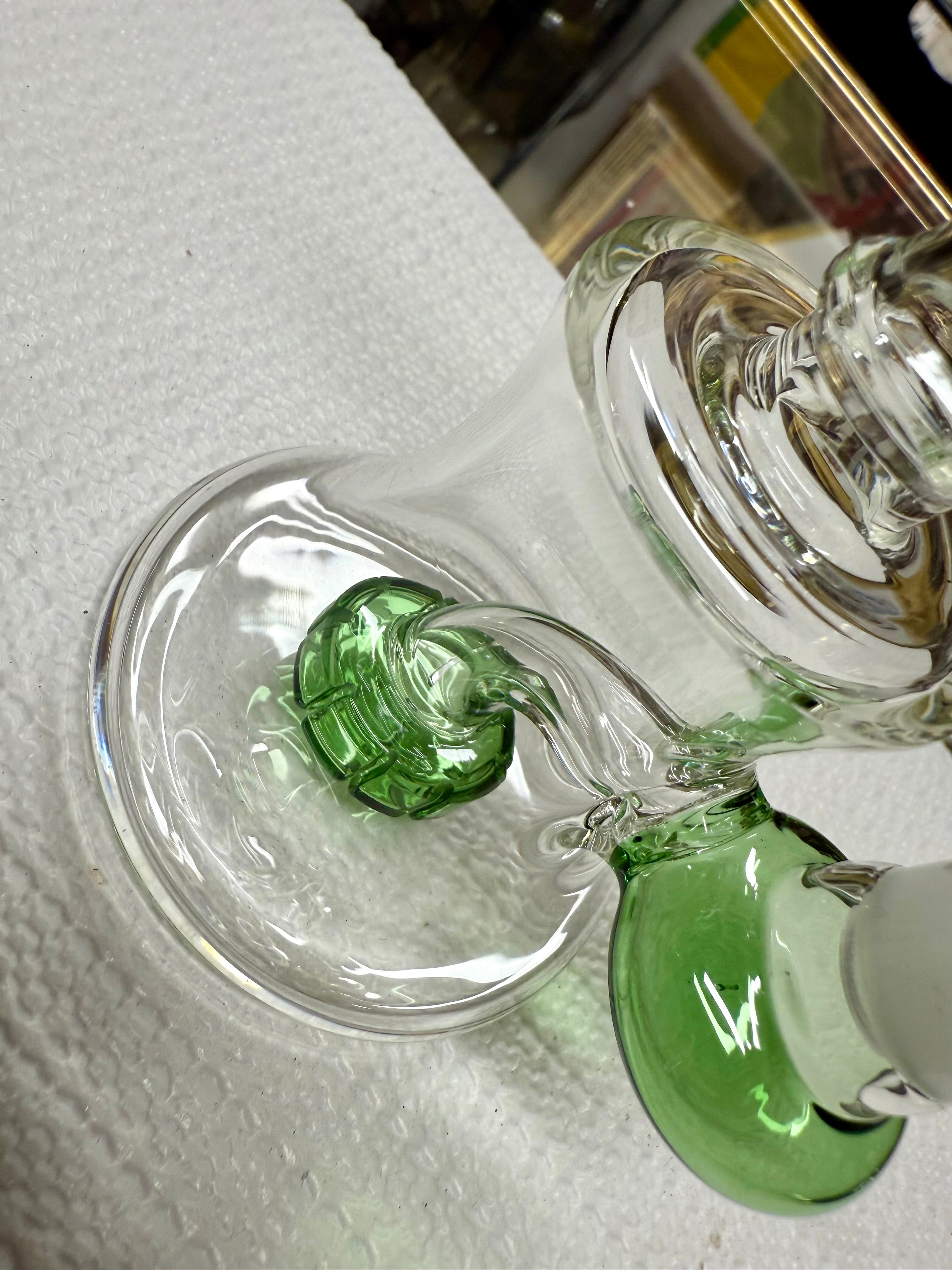 Close-up of Ripkitty 7" bong base — green sculpted percolator base accent with clear bell chamber and downstem joint detail