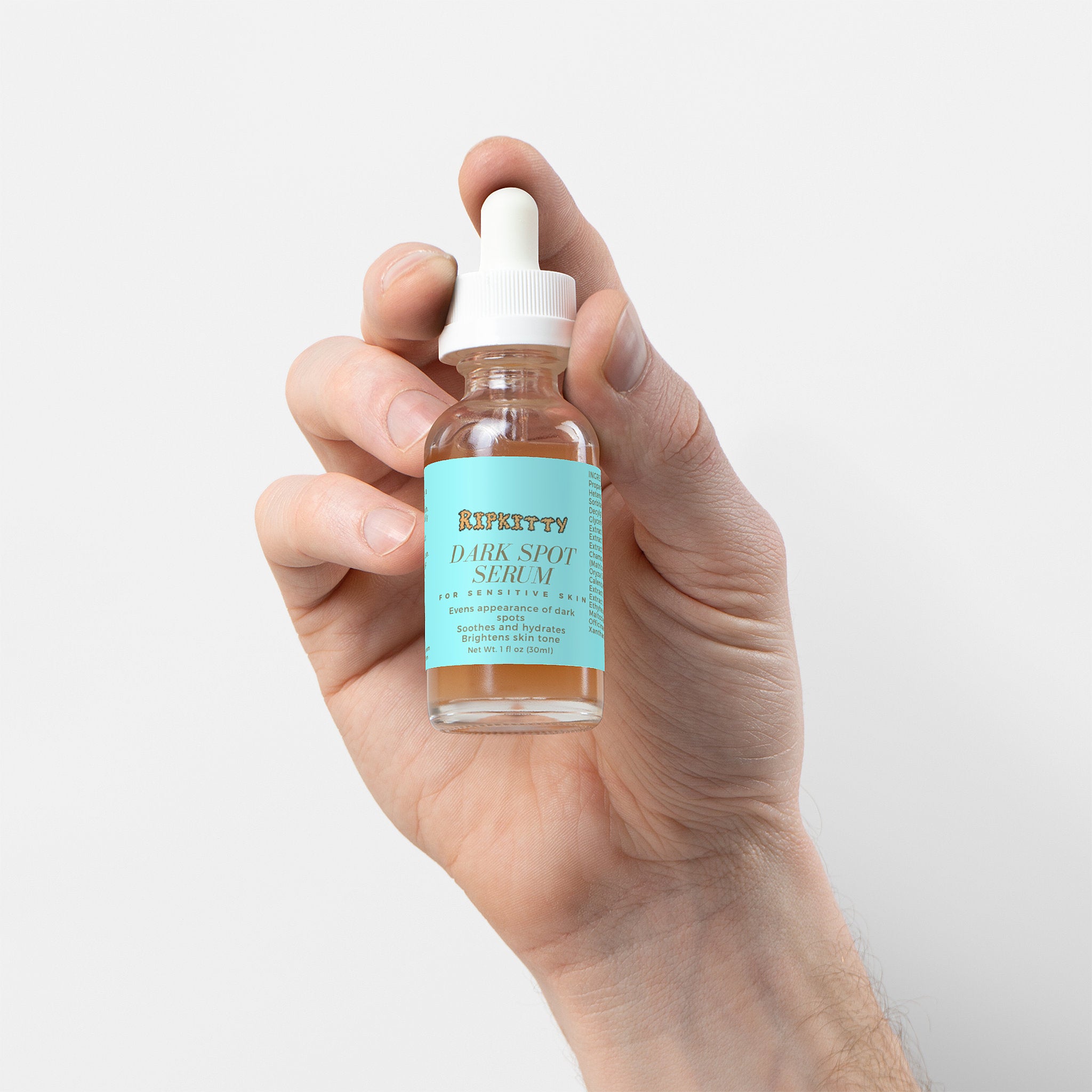 Hand holding a bottle of Kiehl's Dark Spot serum against a light background