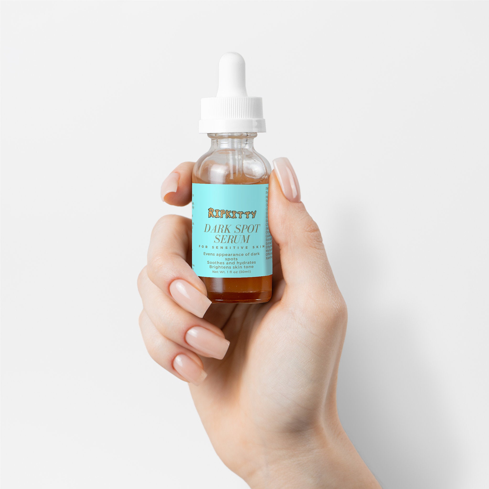 Hand holding a bottle of Skintuity Dark Spot Serum against a light background