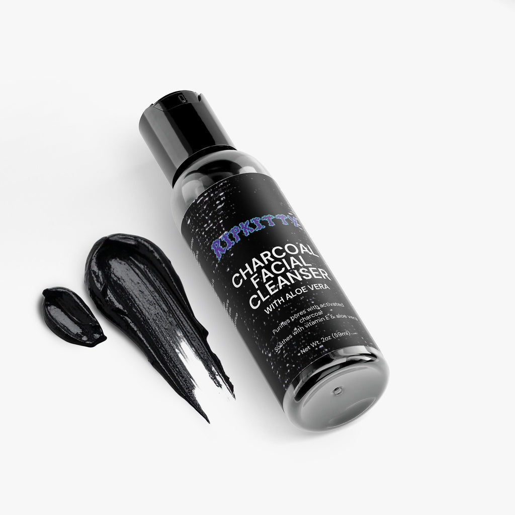 Black bottle of Charcoal Facial Cleanser with a droplet on a white background