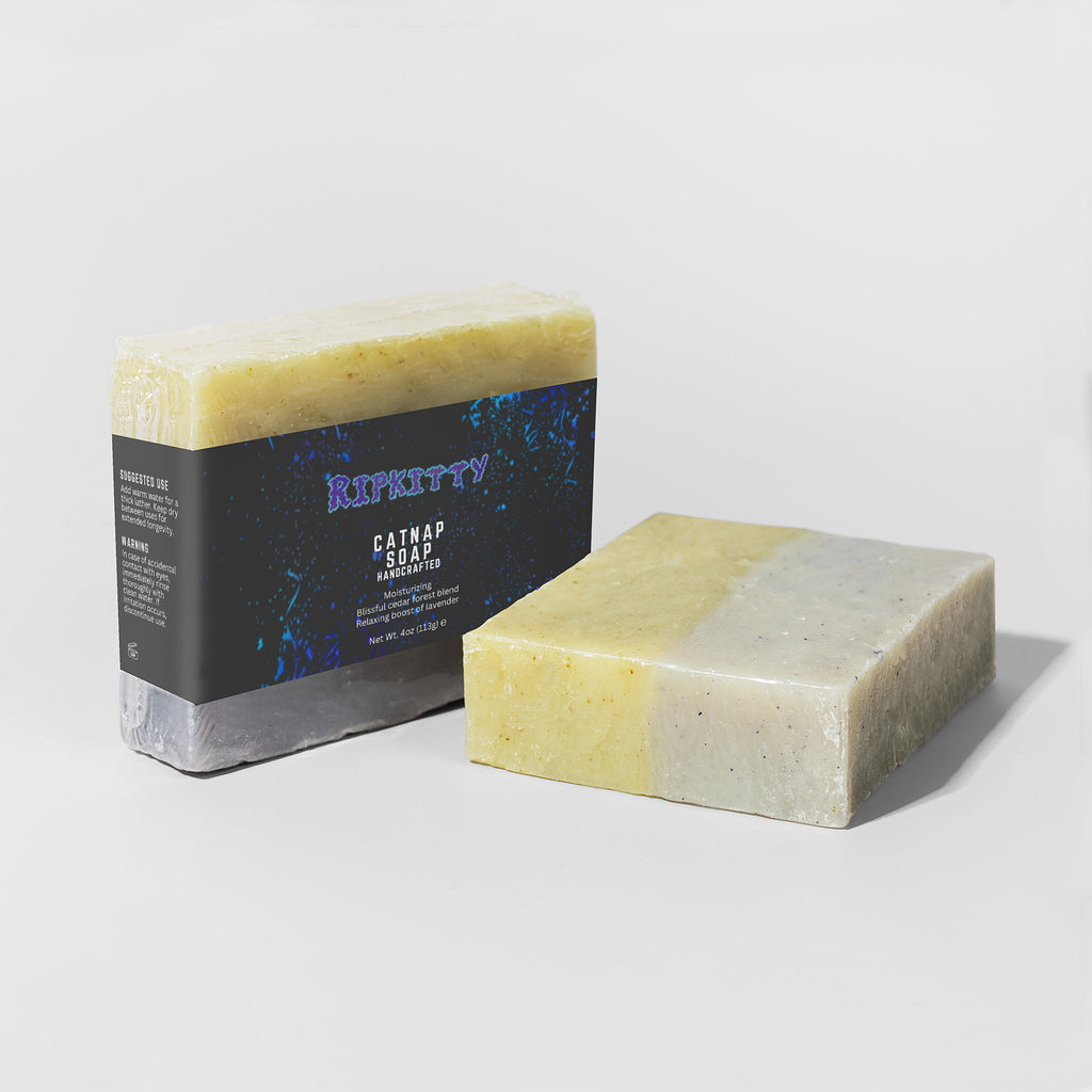 Two bars of soap, one with a visible label, on a light gray background