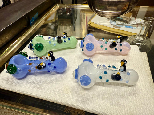 Four Ripkitty 4.5" penguin art spoon pipe — side profile showing sculpted penguin trio and dotted body, white background