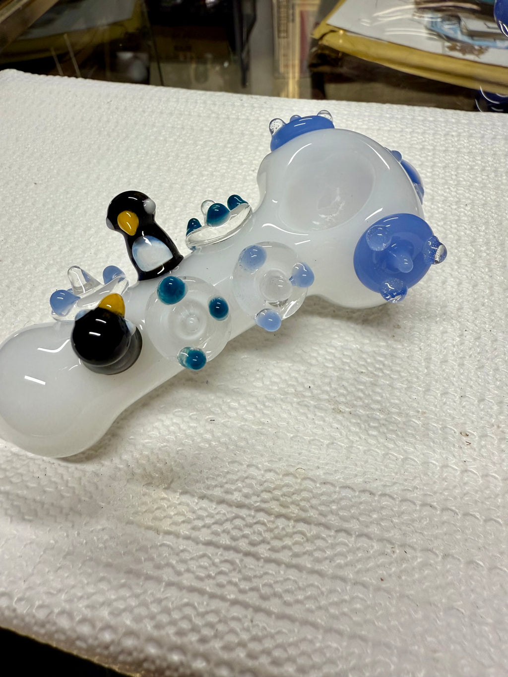  Ripkitty 4.5" penguin art pipe — white colorway, angled view showing penguin trio sculpts and blue polka dot body