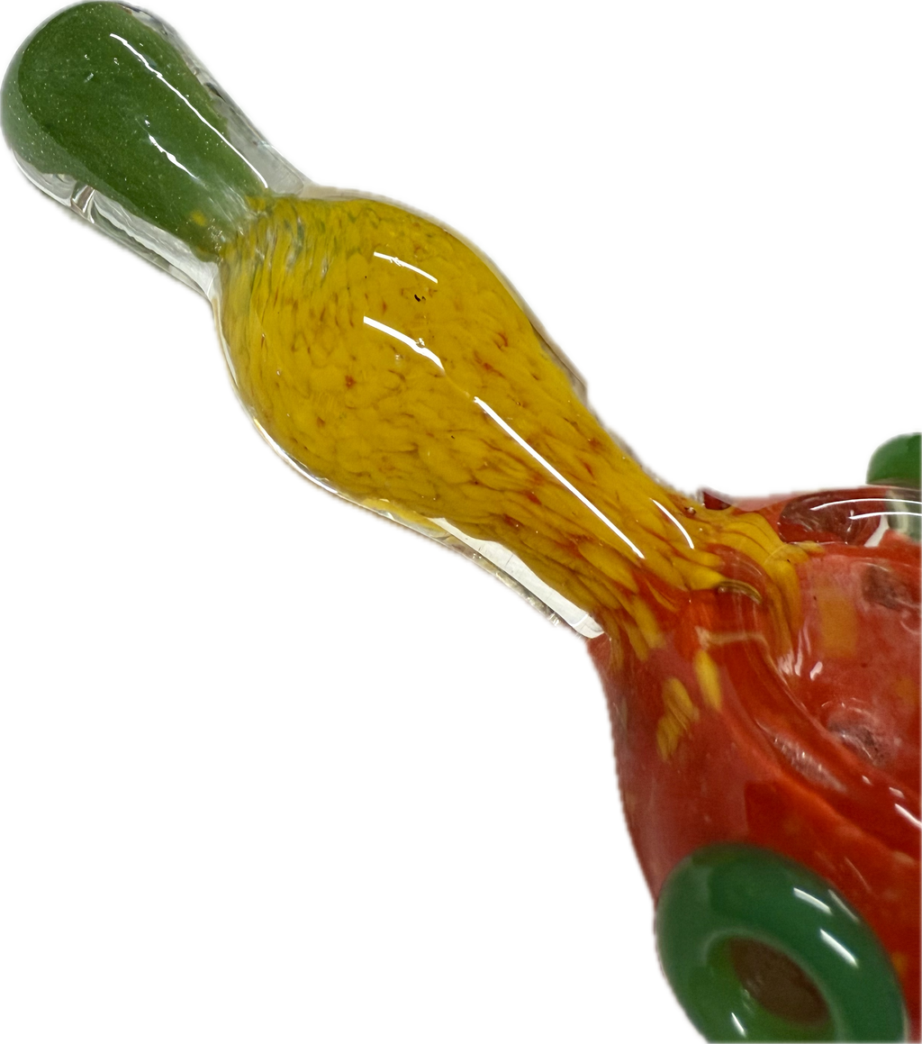 Macro close-up of Ripkitty rasta spoon pipe neck — yellow frit glass detail with green mouthpiece tip and red bowl base visible