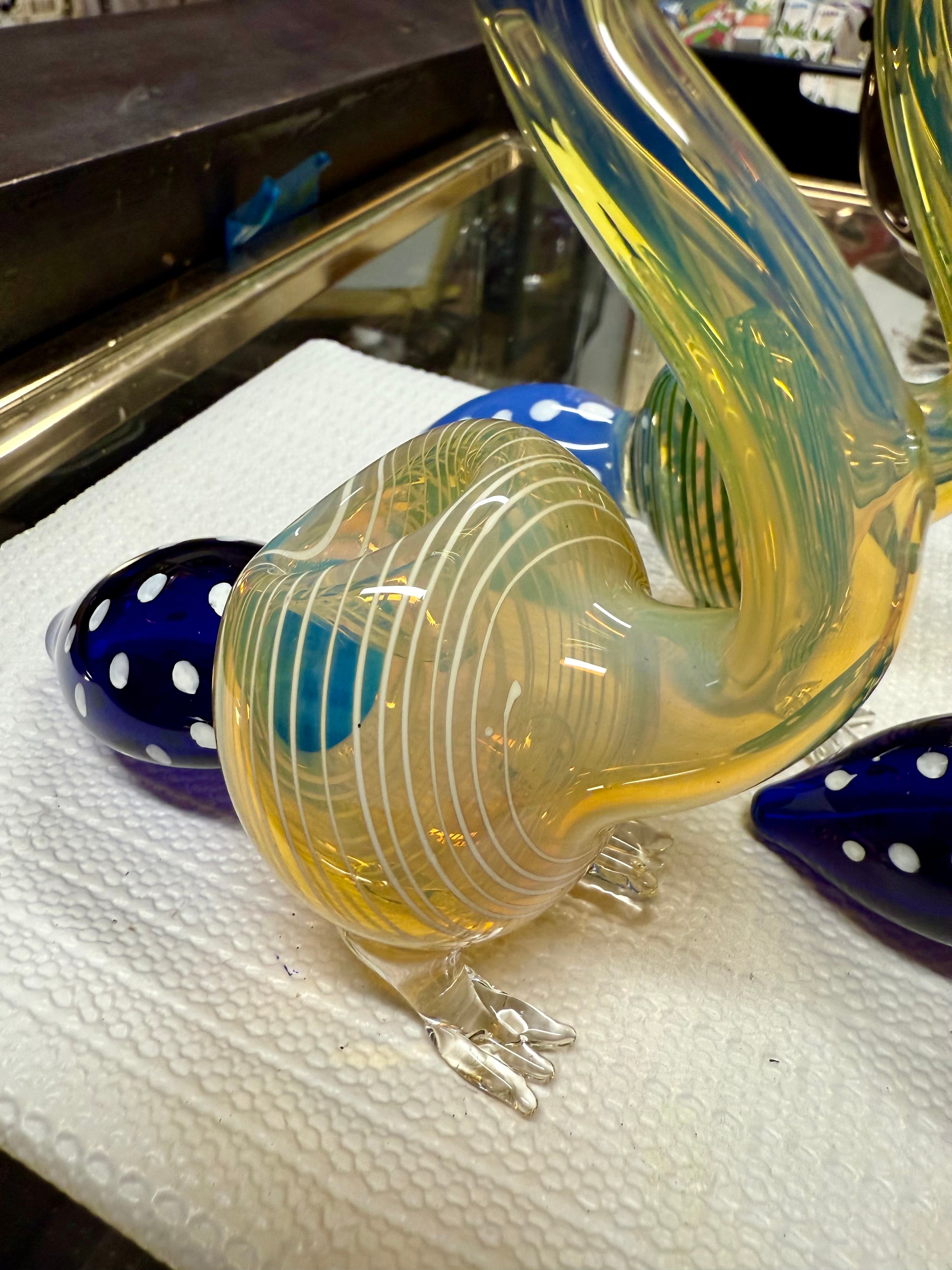 Ripkitty peacock art pipe — angled view of yellow-amber body with teal swirl stripes, sculpted feet, and blue polka-dot bowl chamber