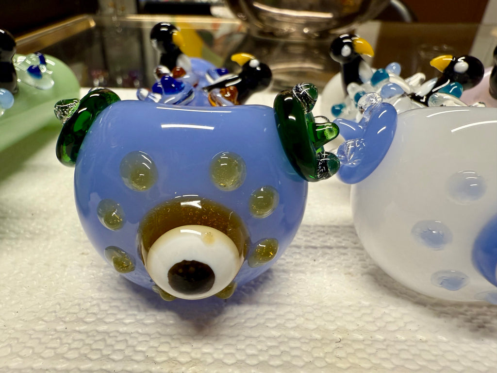 Ripkitty 4.5" penguin art pipe — side profile close-up of periwinkle blue body with sculpted black and white penguin accents