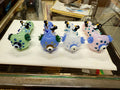 Ripkitty 4.5" penguin art borosilicate glass spoon pipes — with polka dots, sculpted penguin figures on top, evil eye bowl accent, white background