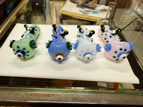 Ripkitty 4.5" penguin art borosilicate glass spoon pipes — with polka dots, sculpted penguin figures on top, evil eye bowl accent, white background
