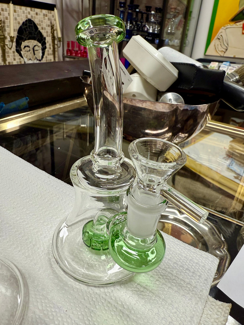 Ripkitty 7" conical bong — color shower iridescent neck, green base accent, three-quarter view showing flared mouthpiece, twisted neck, and 14mm bowl