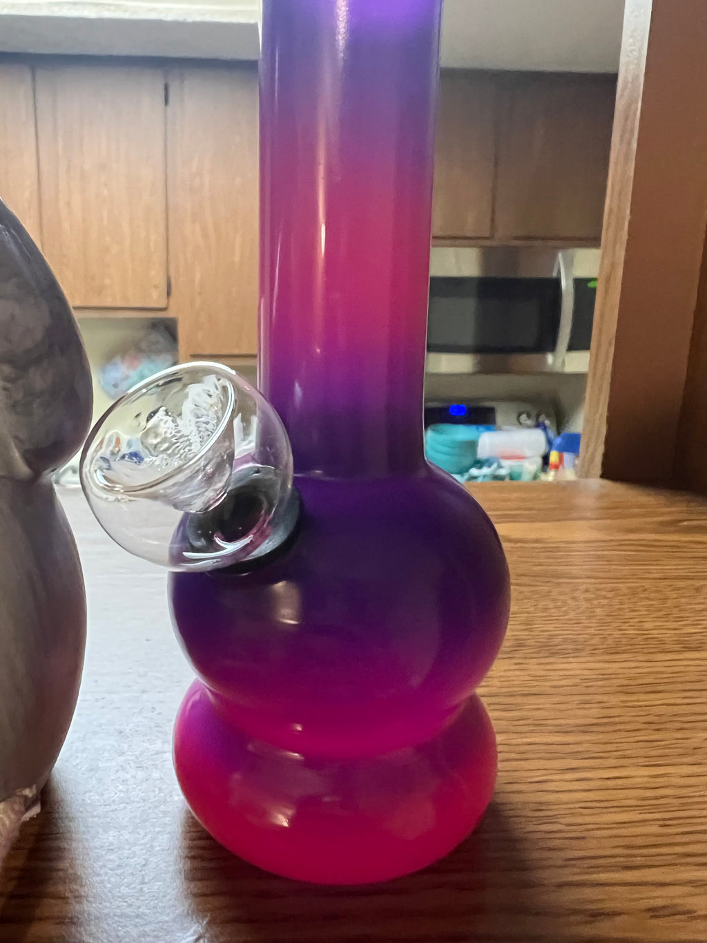 Ripkitty 5-inch soft glass water pipe, purple to pink gradient colorway, double-bubble base, clear glass bowl inserted, wooden table surface