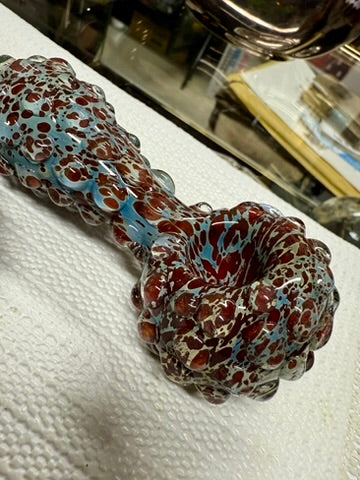 Ripkitty 5" blue spike spoon pipe — teal-blue and dark red frit, side profile showing full pipe length with raised spike nodules covering neck and bowl, white background