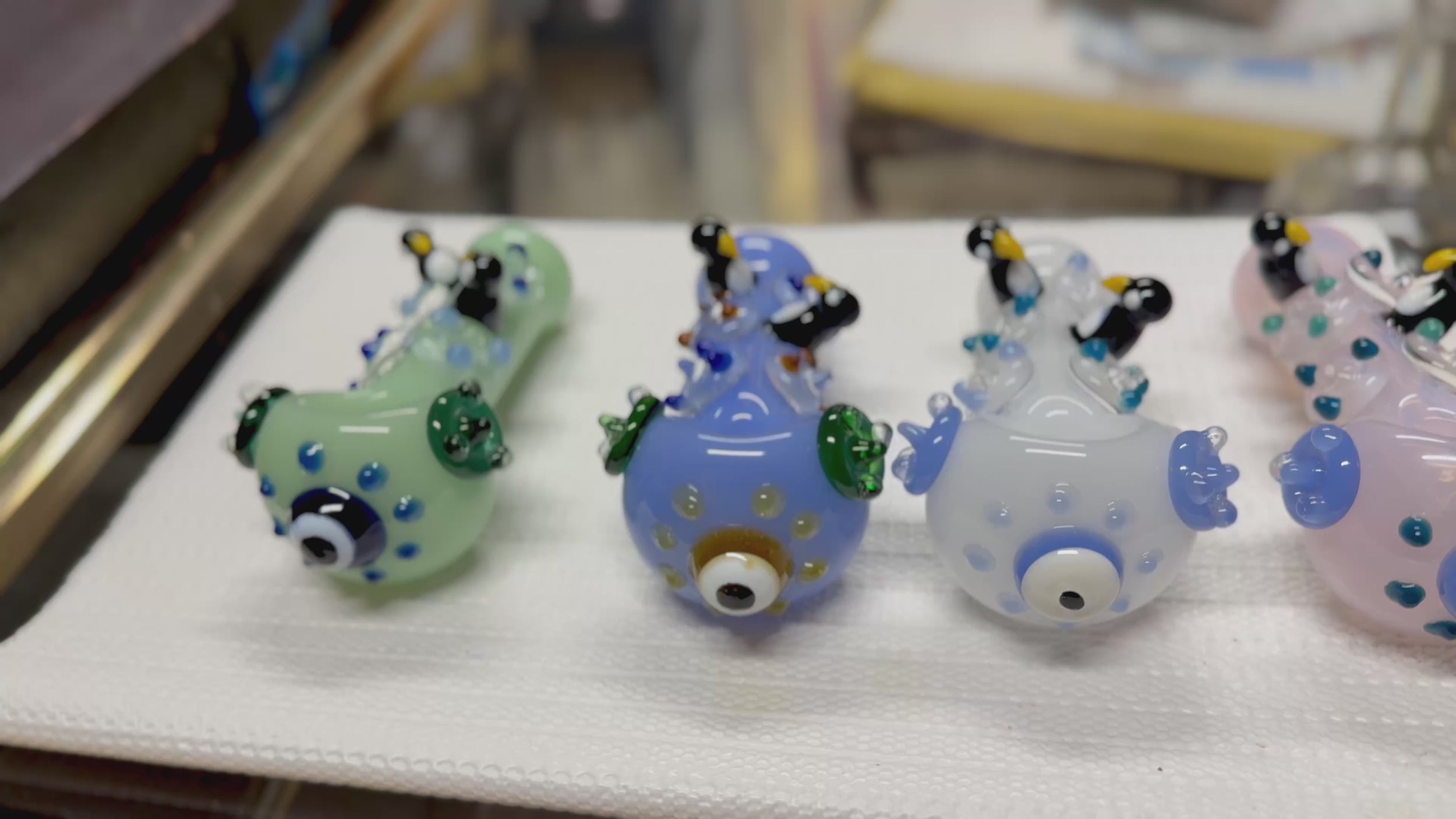 Ripkitty 4.5" penguin art borosilicate glass spoon pipe — 360° display video showing sculpted penguin figures, polka dot body, evil eye bowl, and flipper accents across colorways